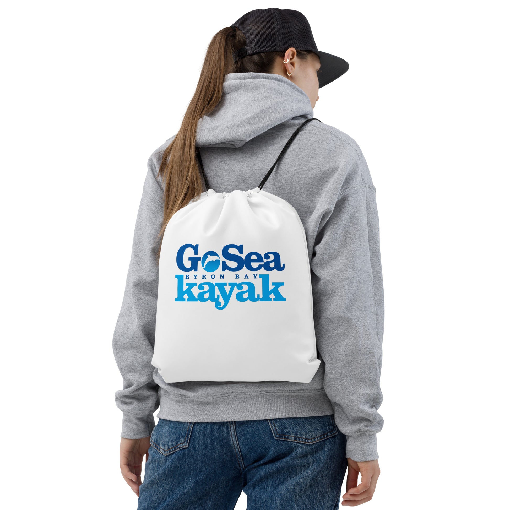  Drawstring Bag - White - Front view - being warn on woman's back - Go Sea Kayak Byron Bay logo on front  - Genuine Byron Bay Merchandise | Produced by Go Sea Kayak Byron Bay 