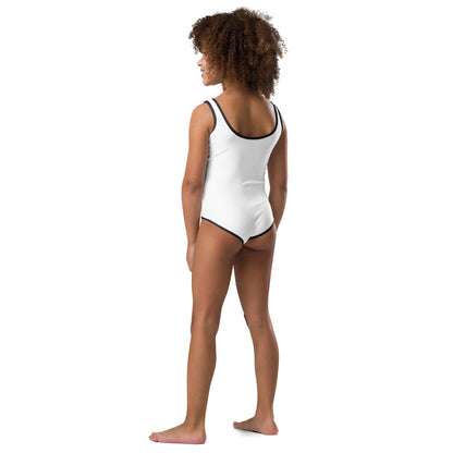  Girls One-Piece Swimsuit - White with black trim/detail - Back view of the swimsuit on a girl standing with her hands resting by her side - With Go Sea Kayak Byron Bay logo on front - Genuine Byron Bay Merchandise | Produced by Go Sea Kayak Byron Bay 