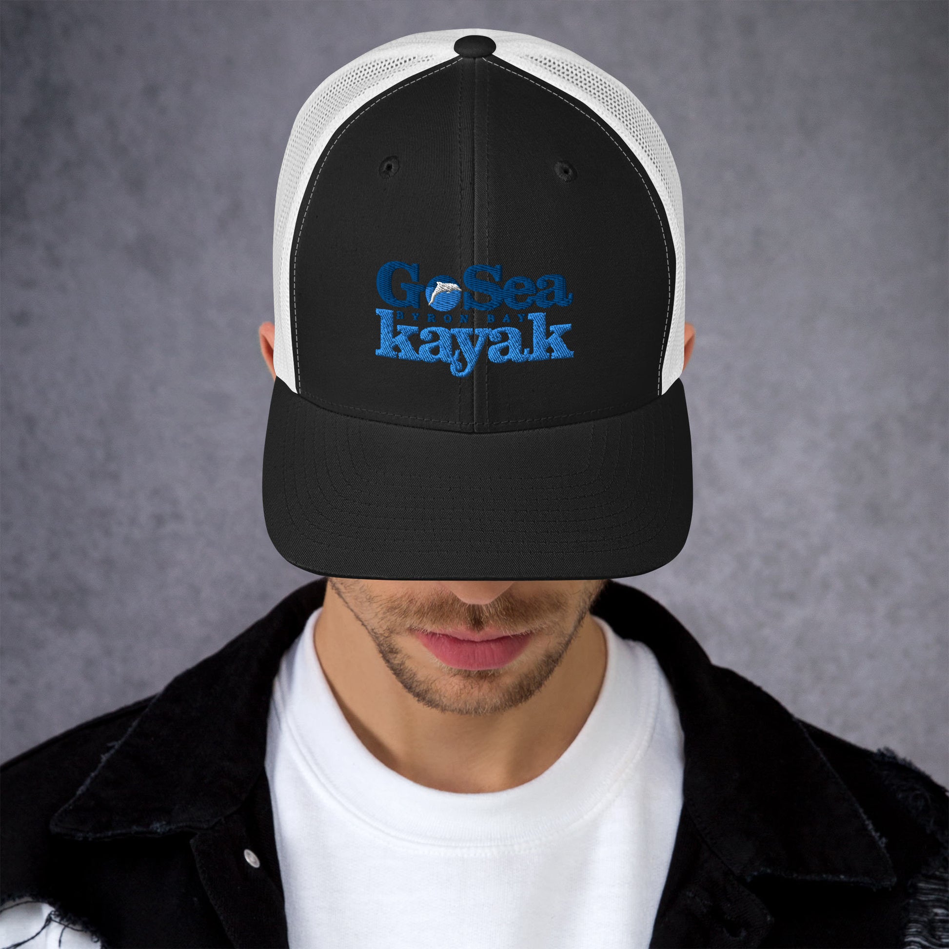  Trucker Cap - Black/White - Front view - being warn by man with his head down - Go Sea Kayak Byron Bay logo on front - Genuine Byron Bay Merchandise | Produced by Go Sea Kayak Byron Bay 