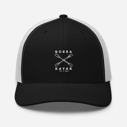  Trucker Cap - Black/White - Front view - being warn by man - Crossed Paddles Go Sea Kayak Crew logo in white on front - Genuine Byron Bay Merchandise | Produced by Go Sea Kayak Byron Bay 