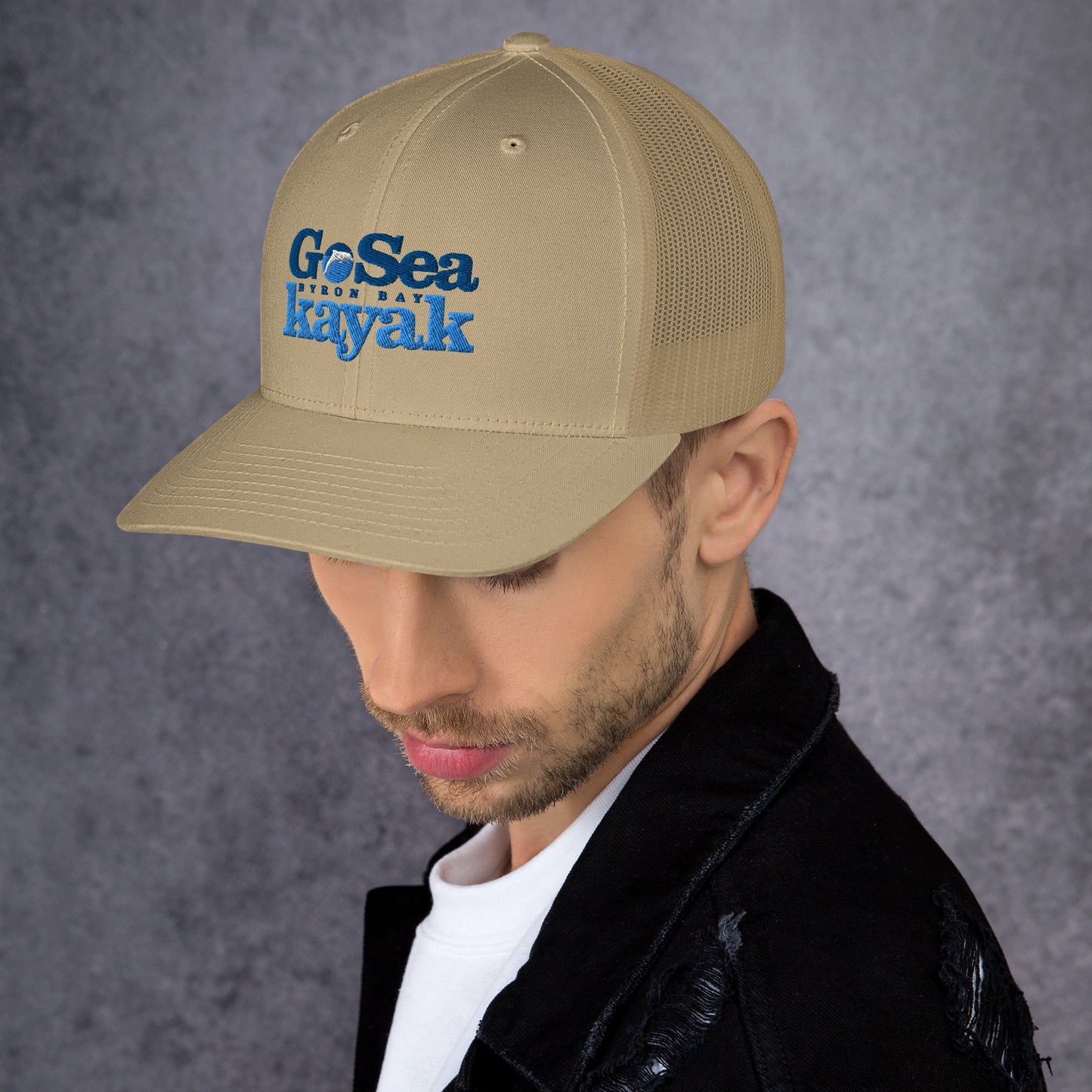  Trucker Cap - Khaki - Side view - being warn by man with his head down - Go Sea Kayak Byron Bay logo on front - Genuine Byron Bay Merchandise | Produced by Go Sea Kayak Byron Bay 