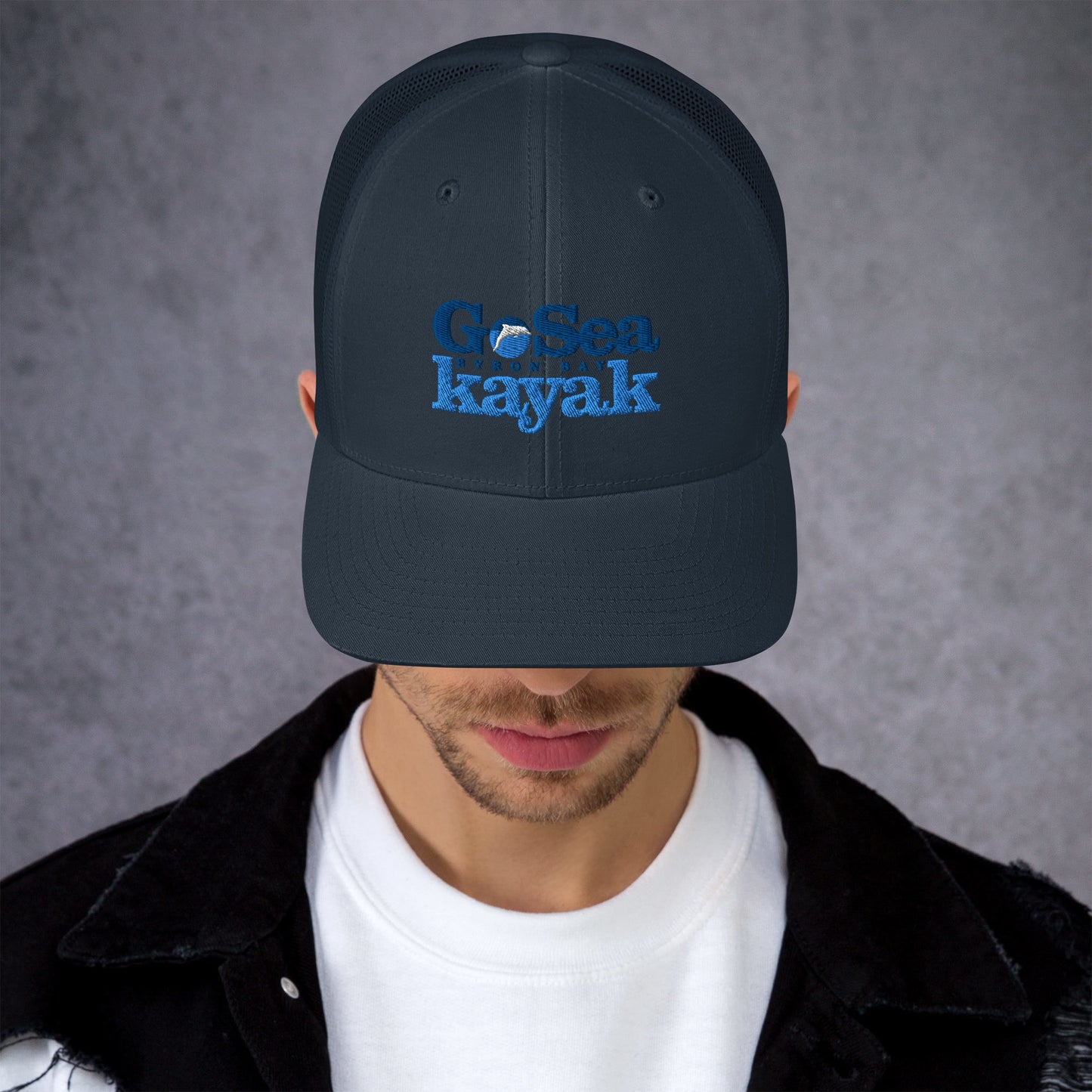  Trucker Cap - Navy - Front view - being warn by man with his head down - Go Sea Kayak Byron Bay logo on front - Genuine Byron Bay Merchandise | Produced by Go Sea Kayak Byron Bay 