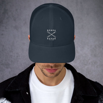  Trucker Cap - Navy - Front view - being warn by man with his head down - Crossed Paddles Go Sea Kayak Crew logo in white on front - Genuine Byron Bay Merchandise | Produced by Go Sea Kayak Byron Bay 