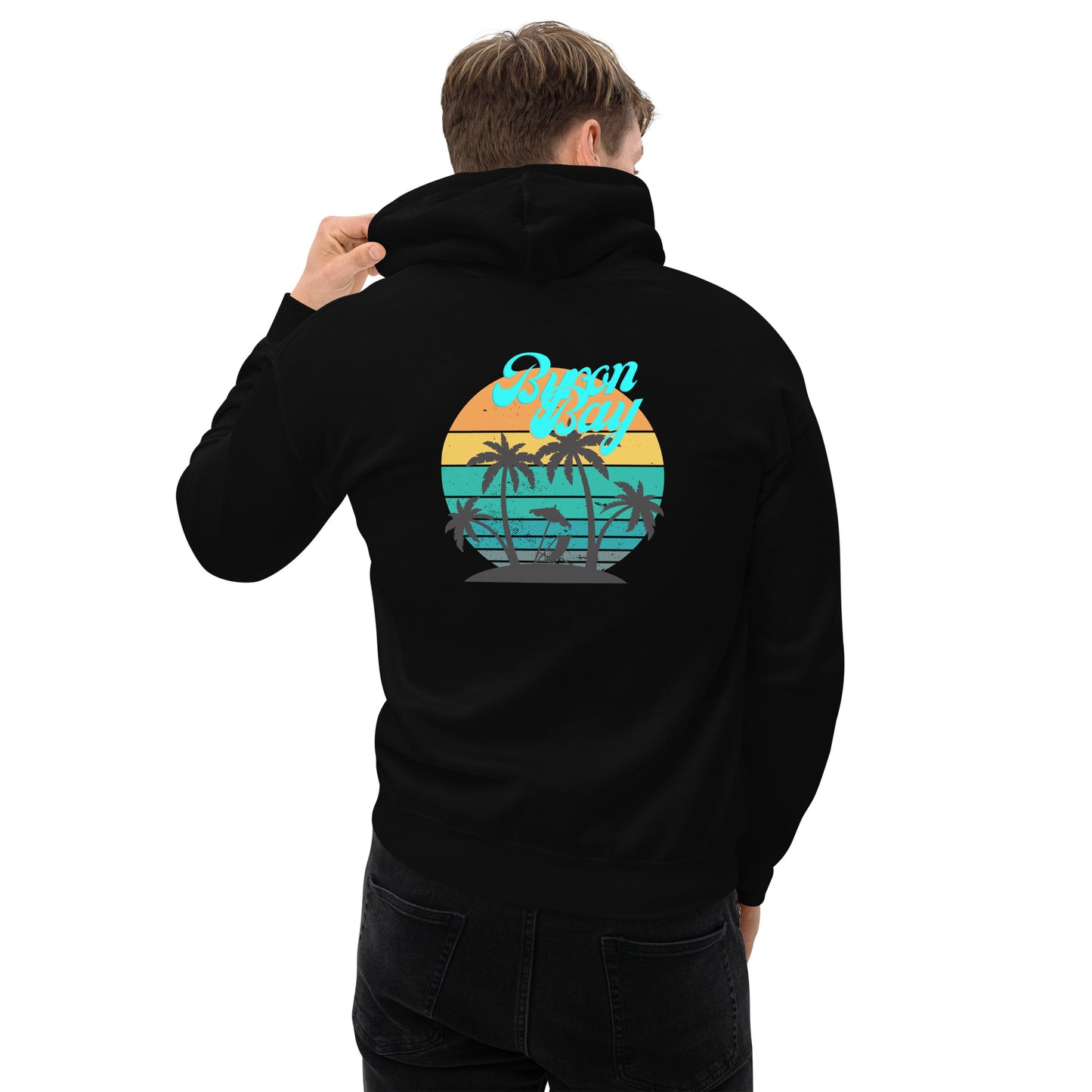  Unisex Hoodie - Black - Back view being warn by man with one hand holding the hood - Byron Bay design on back, plain front with pouch pocket - Genuine Byron Bay Merchandise | Produced by Go Sea Kayak Byron Bay 