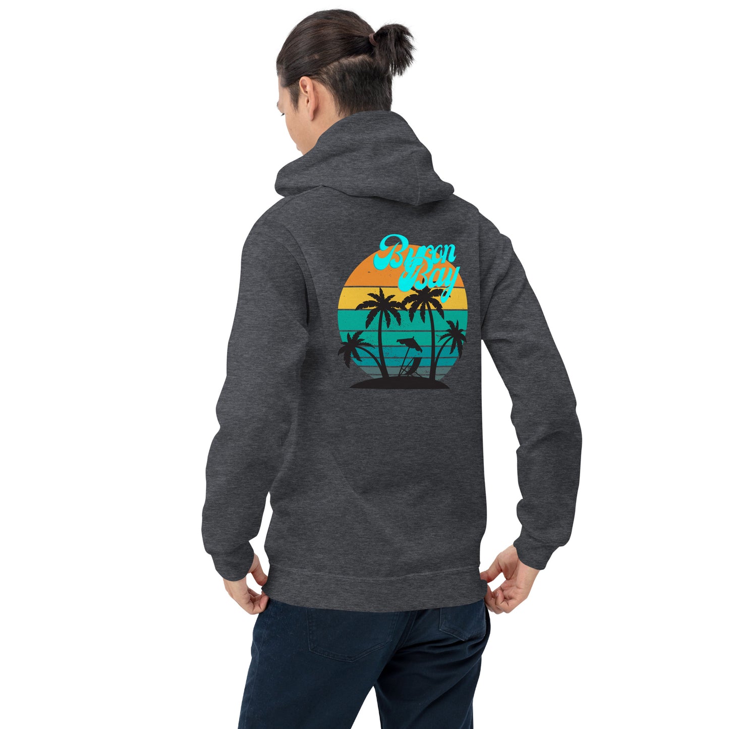  Unisex Hoodie - Dark Heather/Grey - Back view being warn by woman with her hands holding the bottom of the hoodie - Byron Bay design on back, plain front with pouch pocket - Genuine Byron Bay Merchandise | Produced by Go Sea Kayak Byron Bay 