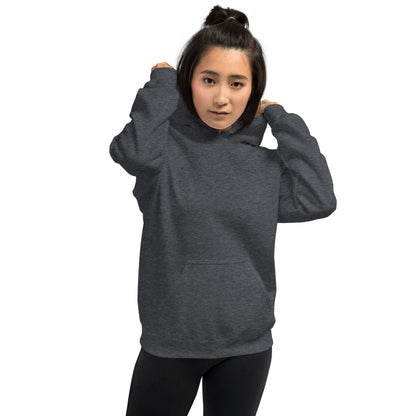  Unisex Hoodie - Dark Heather/Grey - Front view being warn by woman pulling the hood over her head - Byron Bay design on back, plain front with pouch pocket - Genuine Byron Bay Merchandise | Produced by Go Sea Kayak Byron Bay 