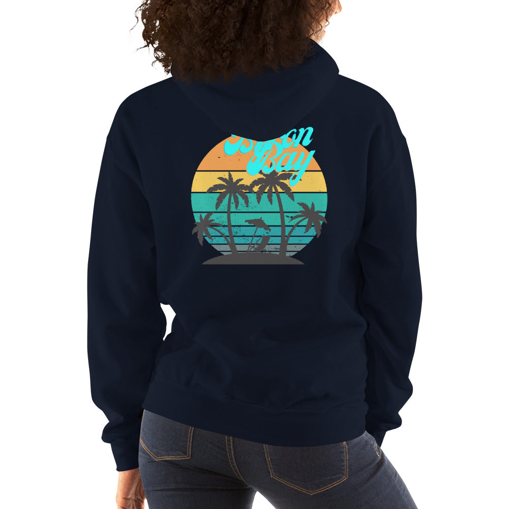  Unisex Hoodie - Navy - Back view being warn by woman with her arms by her side - Byron Bay design on back, plain front with pouch pocket - Genuine Byron Bay Merchandise | Produced by Go Sea Kayak Byron Bay 