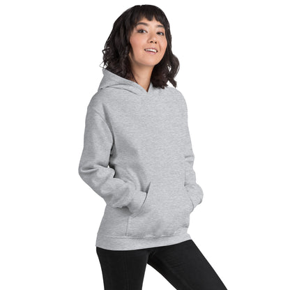  Unisex Hoodie - Sport Grey - Front view being warn by woman with both her hands in the pocket - Byron Bay design on back, plain front with pouch pocket - Genuine Byron Bay Merchandise | Produced by Go Sea Kayak Byron Bay 