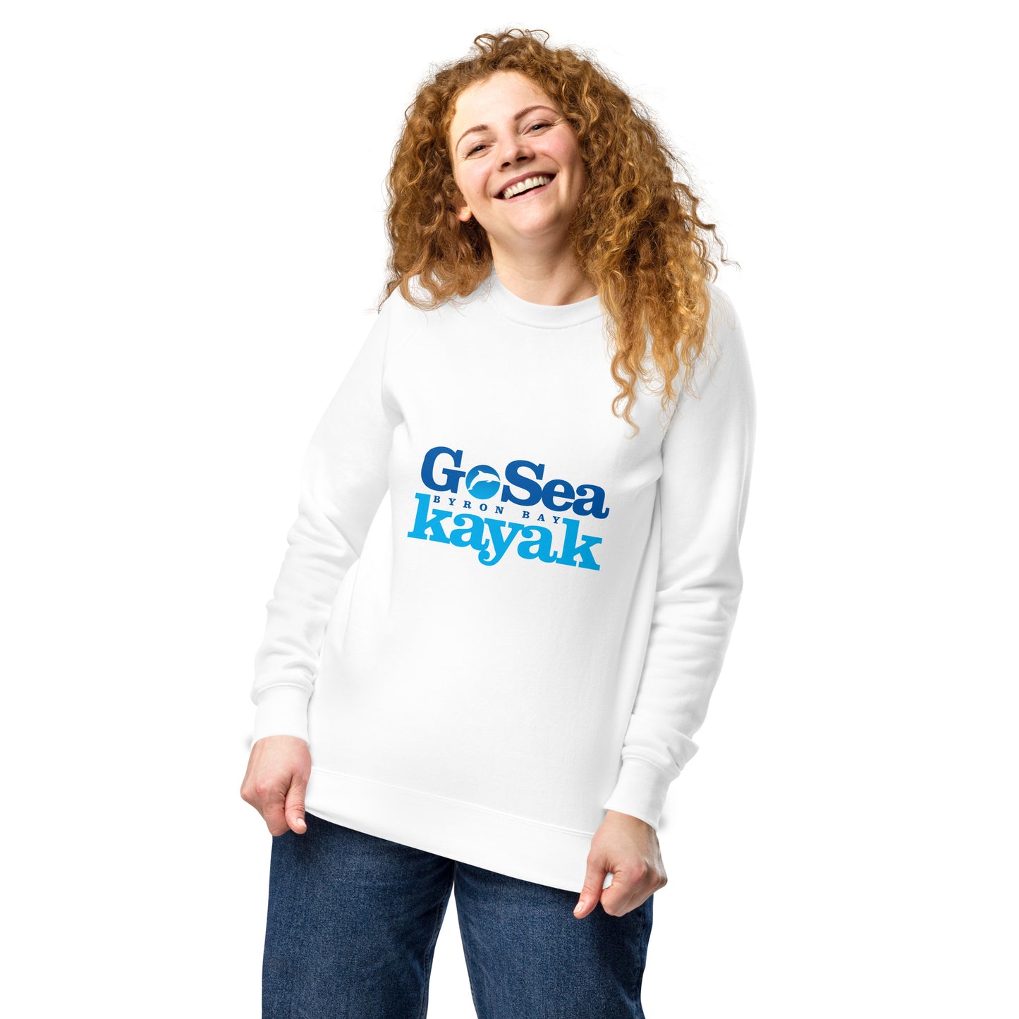 Unisex Sweatshirt - White - Front view, being warn by woman holding the bottom of the jumper - Go Sea Kayak Byron Bay logo on front - Genuine Byron Bay Merchandise | Produced by Go Sea Kayak Byron Bay 