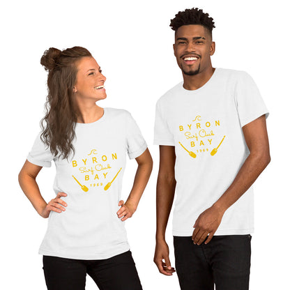  Unisex T-Shirt - White - Front view, on woman and man standing next to eachother - yellow Byron Bay Surf Club logo on front - Genuine Byron Bay Merchandise | Produced by Go Sea Kayak Byron Bay 