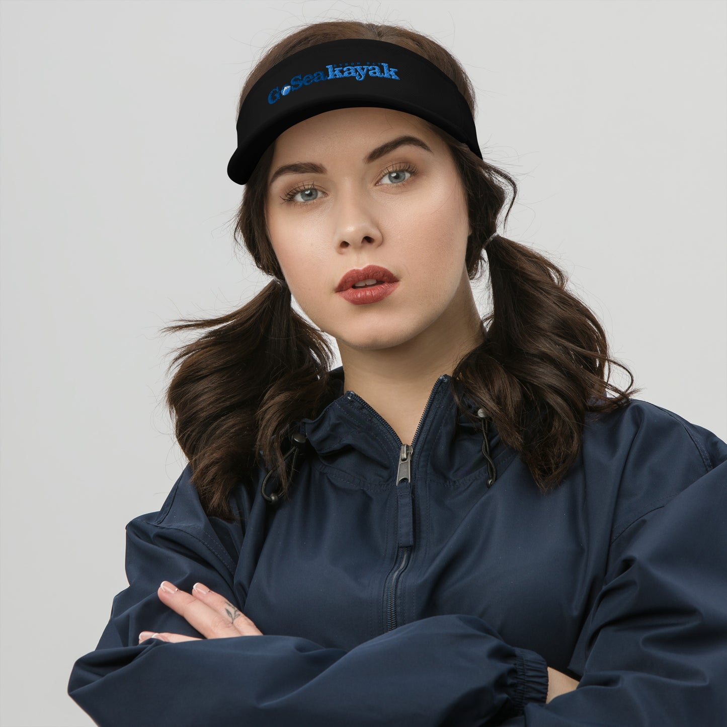  Visor - Black - Front view, on woman standing with arms crossed - Go Sea Kayak Byron bay logo on front - Genuine Byron Bay Merchandise | Produced by Go Sea Kayak Byron Bay 
