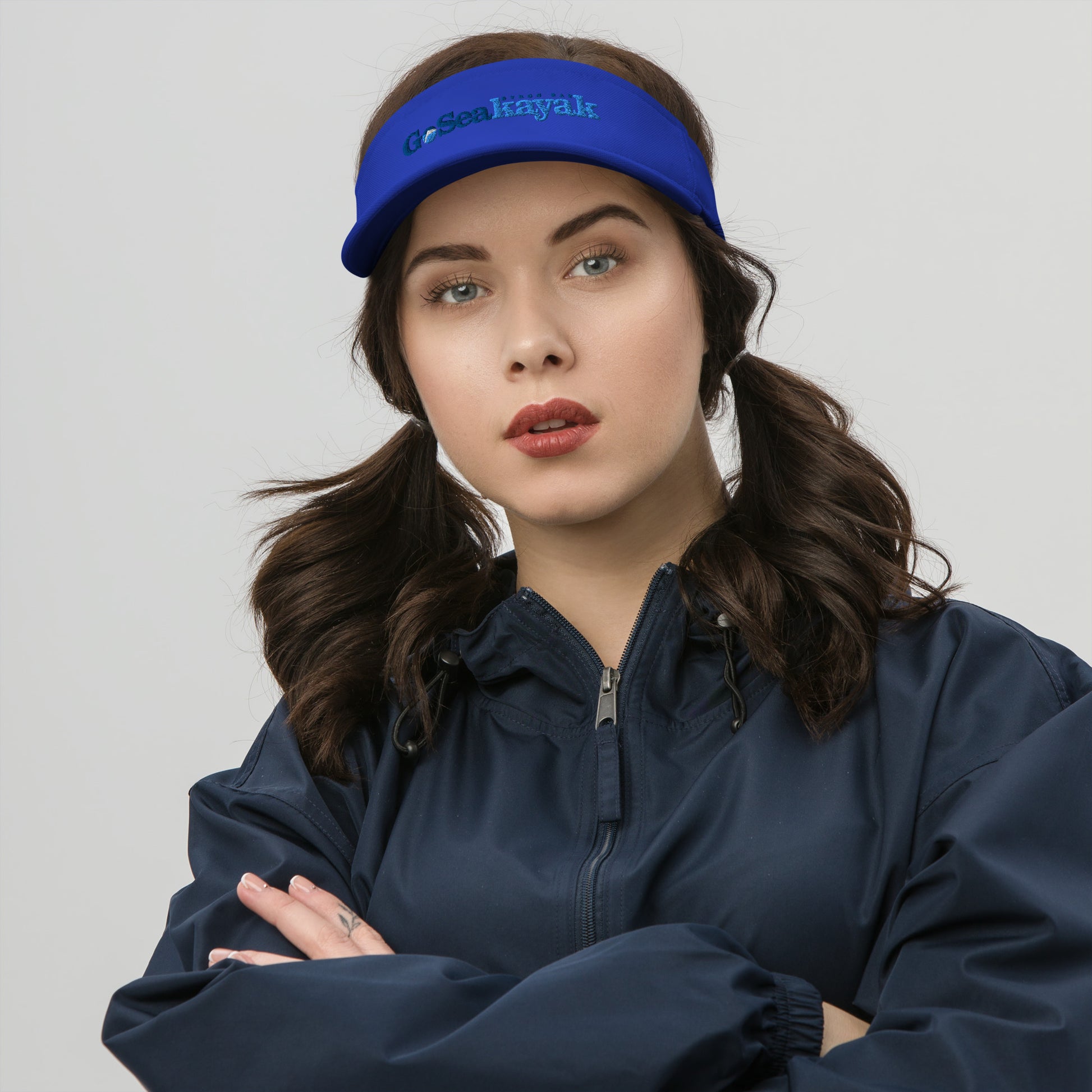  Visor - Royal Blue - Front view, on woman standing with arms crossed - Go Sea Kayak Byron bay logo on front - Genuine Byron Bay Merchandise | Produced by Go Sea Kayak Byron Bay 