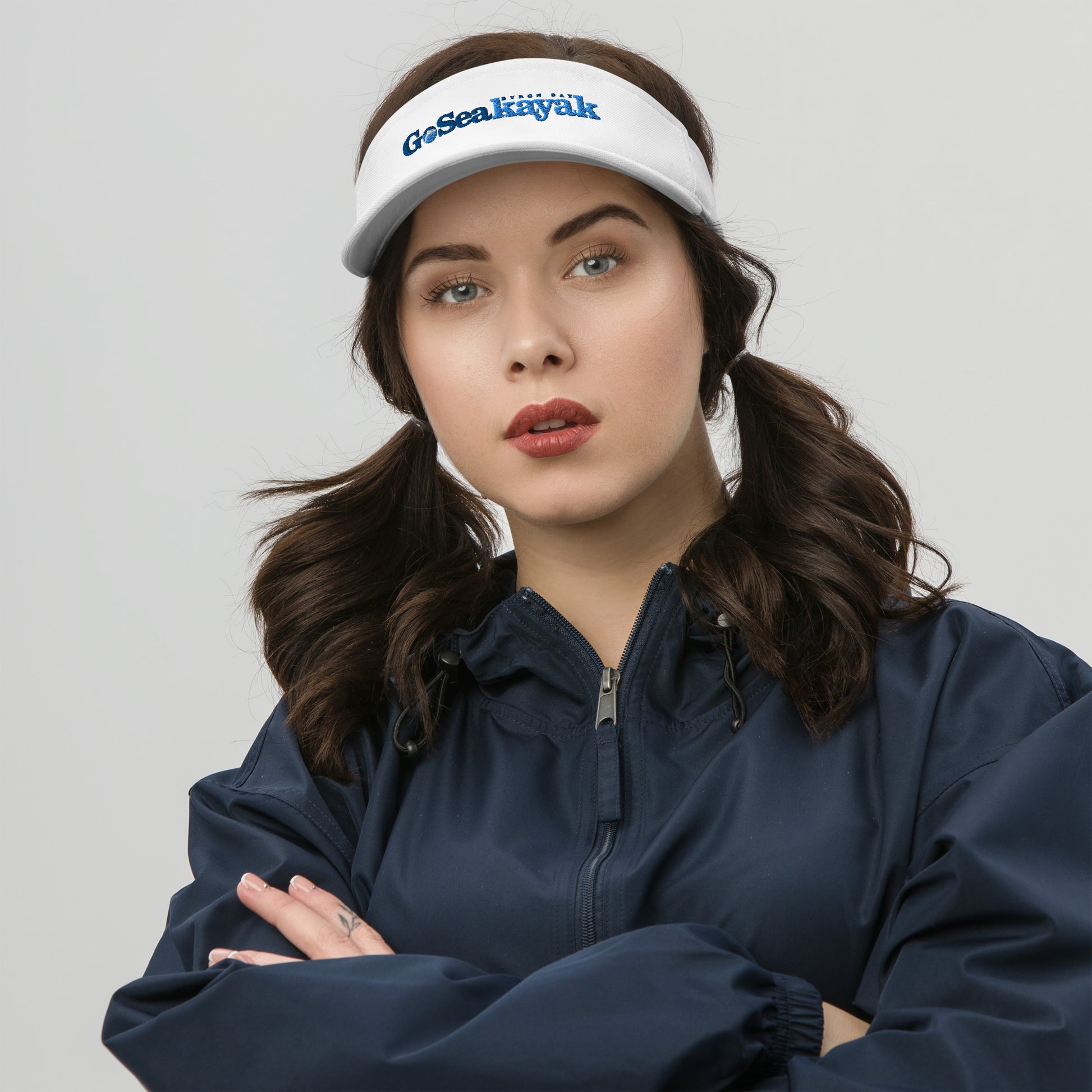  Visor - White - Front view, on woman standing with arms crossed - Go Sea Kayak Byron bay logo on front - Genuine Byron Bay Merchandise | Produced by Go Sea Kayak Byron Bay 