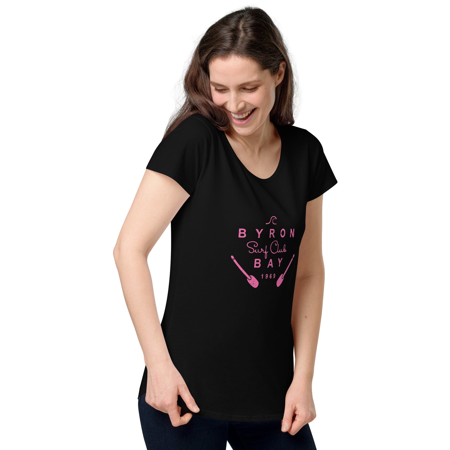  Women’s Round Neck Tee - Black - Front view, being warn by woman holding the bottom of the tee - pink Byron Bay Surf Club logo on front - Genuine Byron Bay Merchandise | Produced by Go Sea Kayak Byron Bay 