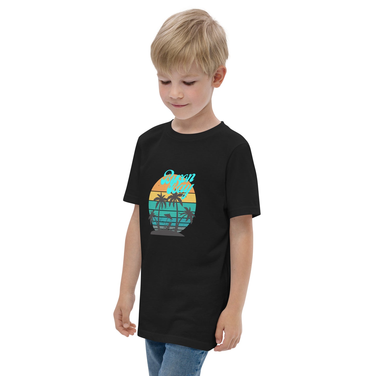  Kids T-Shirt - Black  - Side view, being warn on boy standing with his arms by his side - Byron Bay design on front - Genuine Byron Bay Merchandise | Produced by Go Sea Kayak Byron Bay 