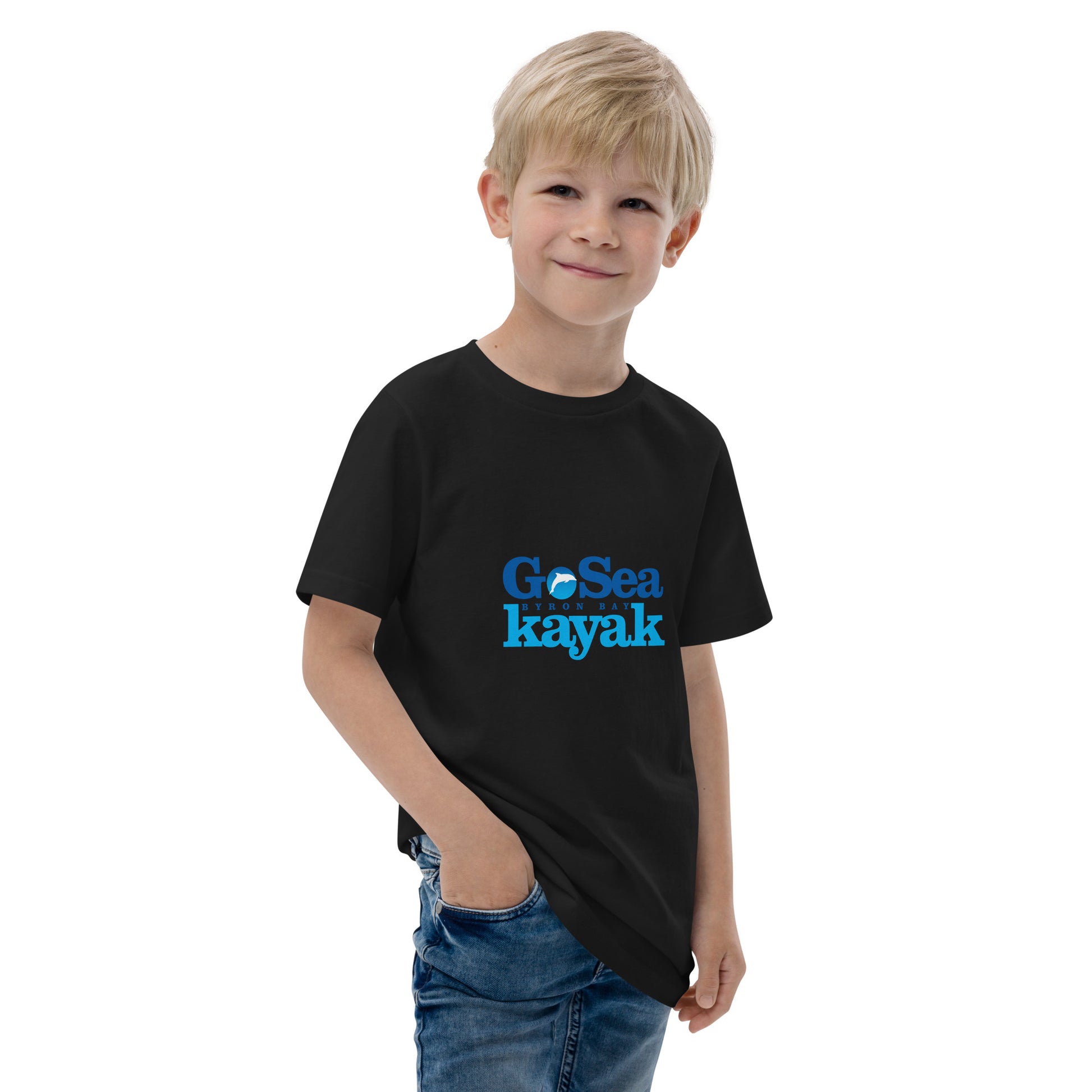  Kids T-Shirt - Black  - Front view, being warn on boy standing with a hand in his pocket - Go Sea Kayak Byron Bay logo on front - Genuine Byron Bay Merchandise | Produced by Go Sea Kayak Byron Bay 