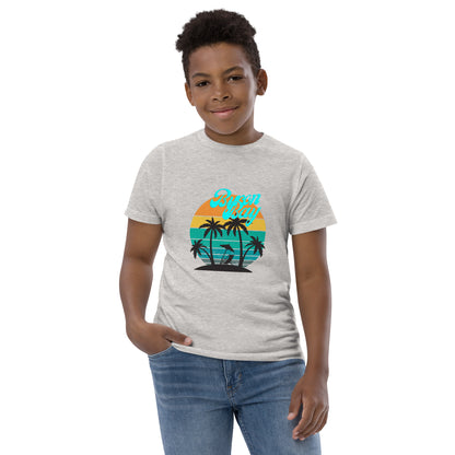  Kids T-Shirt - Natural / Heather colour - Front view, being warn on boy standing with a hand in his pocket - Byron Bay design on front - Genuine Byron Bay Merchandise | Produced by Go Sea Kayak Byron Bay 