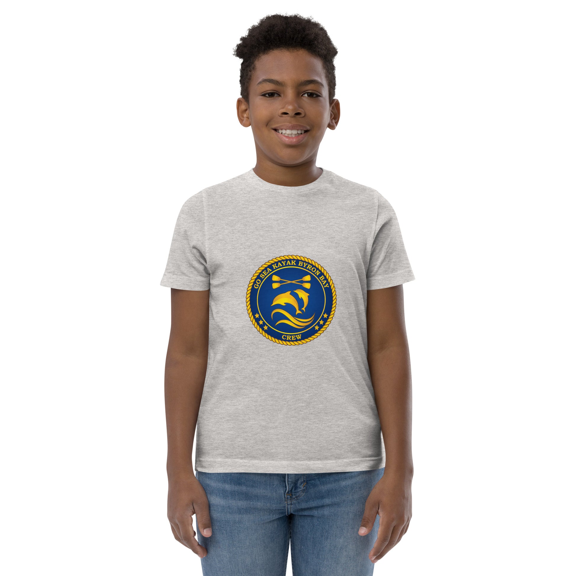  Kids T-Shirt - Natural / Heather colour - Front view, being warn on boy standing with his arms by his side - Go Sea Kayak Byron Bay Crew (issue 2018-2019) logo on front - Genuine Byron Bay Merchandise | Produced by Go Sea Kayak Byron Bay 