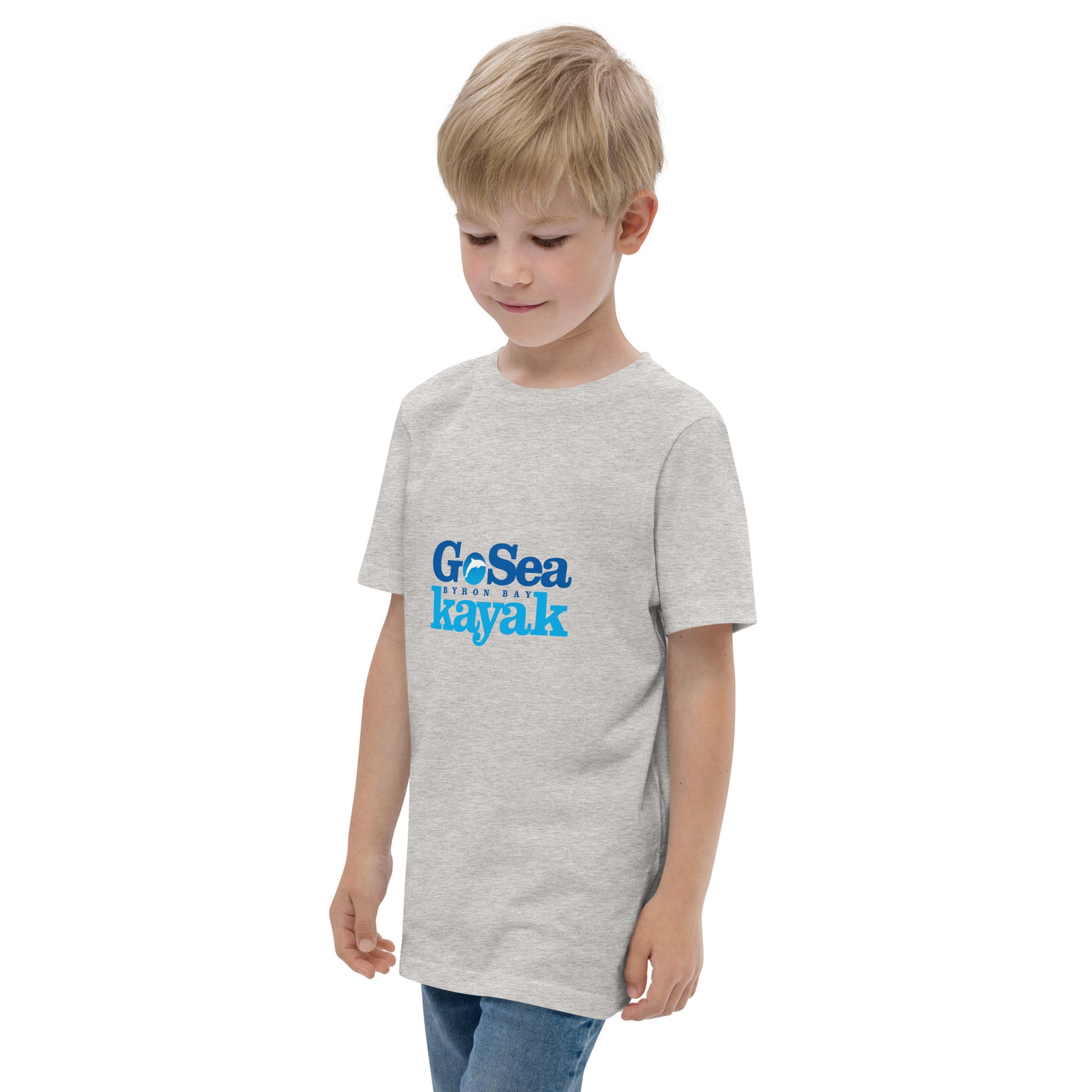  Kids T-Shirt - Natural / Heather colour - side view, being warn on boy standing with his arms by his side - Go Sea Kayak Byron Bay logo on front - Genuine Byron Bay Merchandise | Produced by Go Sea Kayak Byron Bay 