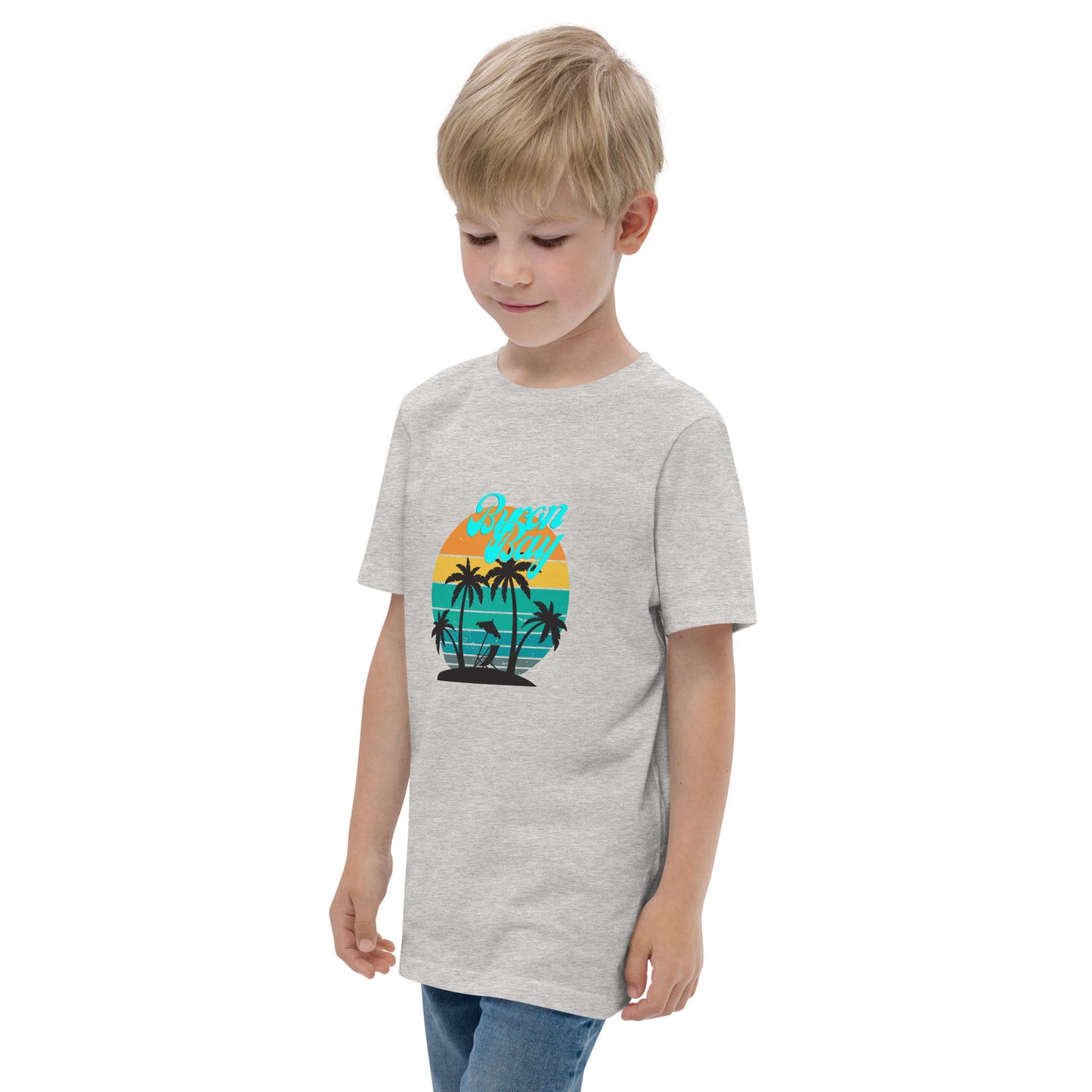  Kids T-Shirt - Natural / Heather colour - Side view, being warn on boy standing with his arms by his side - Byron Bay design on front - Genuine Byron Bay Merchandise | Produced by Go Sea Kayak Byron Bay 