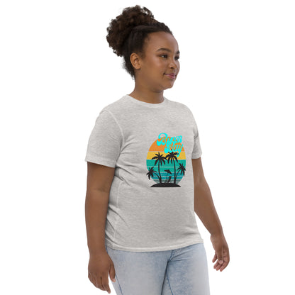 Kids T-Shirt - Natural / Heather colour - side view, being warn on a girl standing with her arms by her side - Byron Bay design on front - Genuine Byron Bay Merchandise | Produced by Go Sea Kayak Byron Bay 