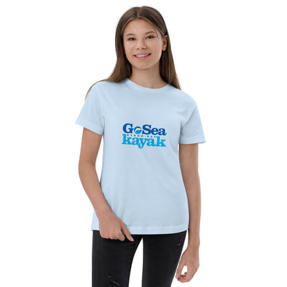  Kids T-Shirt - Light Blue - Front view, being warn on a girl standing with one arm holding the tee  - Go Sea Kayak Byron Bay logo on front - Genuine Byron Bay Merchandise | Produced by Go Sea Kayak Byron Bay 