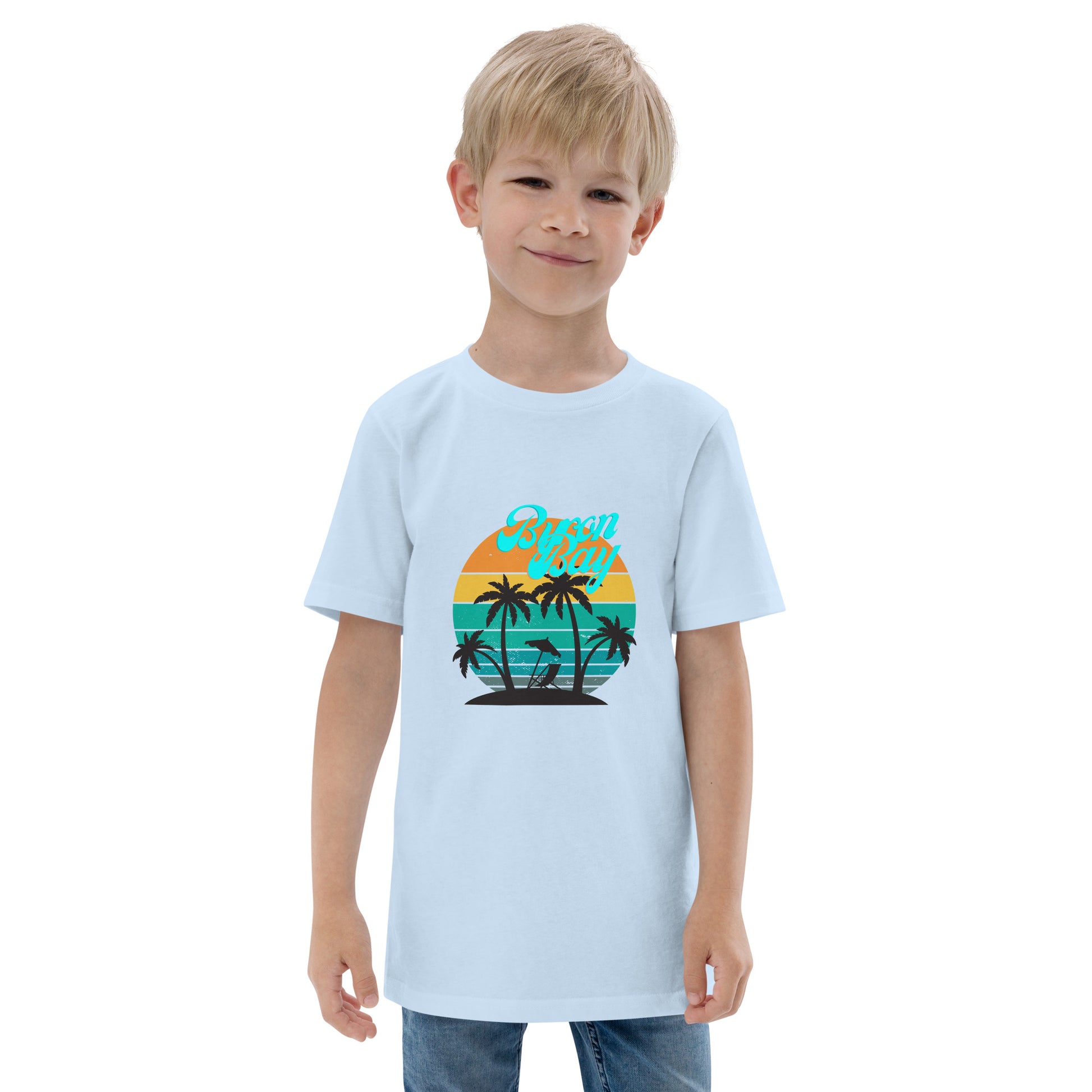  Kids T-Shirt - Light Blue - Front view, being warn on boy standing with his arms by his side - Byron Bay design on front - Genuine Byron Bay Merchandise | Produced by Go Sea Kayak Byron Bay 