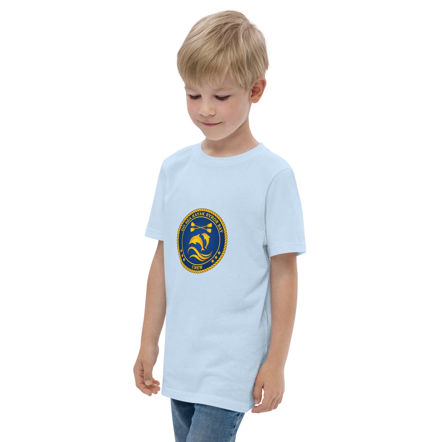  Kids T-Shirt - Light Blue - side view, being warn on boy standing with his arms by his side - Go Sea Kayak Byron Bay Crew (issue 2018-2019) logo on front - Genuine Byron Bay Merchandise | Produced by Go Sea Kayak Byron Bay 