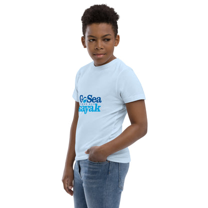  Kids T-Shirt - Light Blue - side view, being warn on boy standing with a hand in his pocket - Go Sea Kayak Byron Bay logo on front - Genuine Byron Bay Merchandise | Produced by Go Sea Kayak Byron Bay 